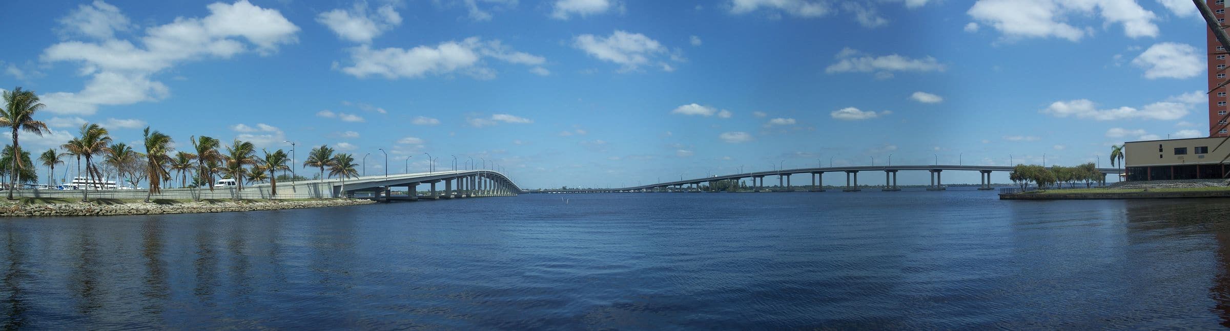 The Caloosahatchee River and the Edison Bridge in Fort Myers, lined with palms